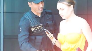 A girl asking undress by a guard.