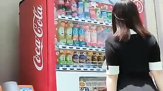 Japanese Girl Taking Drink From Vending Machine