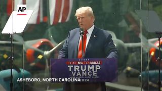Trump holds first outdoor rally since assassination attempt from behind bulletproof glass