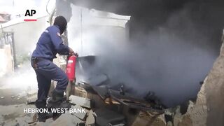 Palestinian firefighters in Hebron, West Bank rush to tackle blaze at house wrecked in Israeli raid.