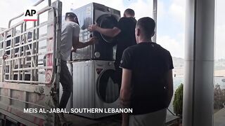 Store owners collect goods for removal in a Lebanese border town amid fears of supply shortage.