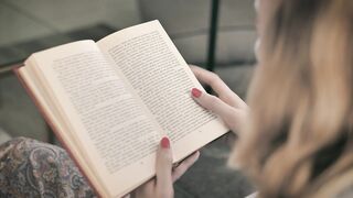 Blonde woman reading book