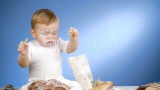 Baby baker playing with pasta