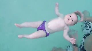 Baby swimming in water and enjoy