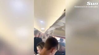 Shocking moment EasyJet passengers flee on evacuation slide after ‘bag of vapes’ EXPLODES.