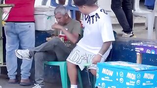 This man is snatching and eating from others