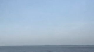 Russian cruise missiles pass by a fishing boat over the Caspian Sea