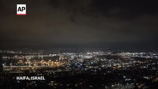 Security personnel clear rubble after sirens and blasts heard in Haifa, northern Israel.