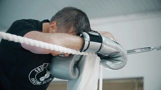 Tired Boxer in Corner of Ring