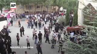 Mourners attend the funeral of 10 Lebanese killed in Israeli airstrike.