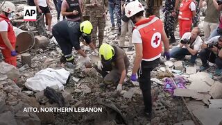 Rescuers remove human remains from site of Israeli airstrike in northern Lebanon.