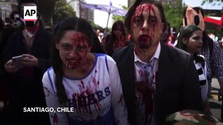 Zombie enthusiasts shuffle through Santiago at annual march for the 'undead'.