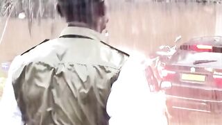 The police officer shows his work while raining.