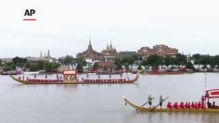 Thailand's king takes part in ancient royal barge procession in Bangkok.