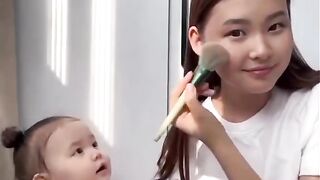 The baby is very cute like his mother