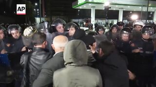 Protesters block roads in Albania to demand caretaker Cabinet.
