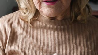 Elderly Woman Holding a Cup of Coffee