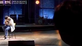 A young boy is playing Guitar beautifully