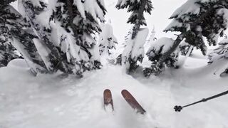 A man was skiing in the snow and suddenly he was surprised by a skier buried under the