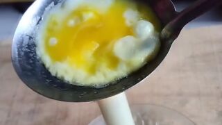Cooking quail eggs using a spoon and candle