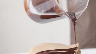 Pouring Chocolate Syrup on Top of Pancakes