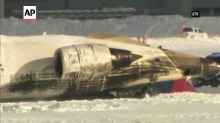 Delta plane crash_ All 80 aboard survive after jet flips upside down on landing in Toronto.mp4
