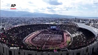 Tens of thousands fill Beirut stadium for funeral of Hezbollah leader.