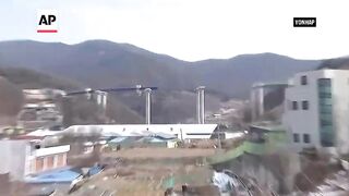 Elevated parts of highway under construction collapse in South Korea, killing workers.