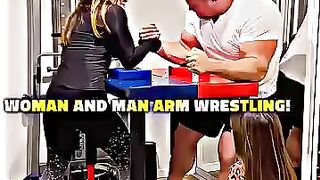 Woman and man arm wrestling