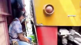 Breathtaking scenes.. Train crossing in the middle of the vegetable market. Thailand