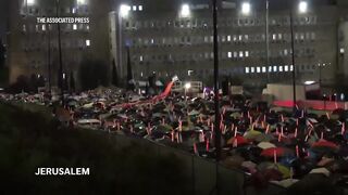 Thousands gather outside Israeli PM's office to protest plan to fire head of internal security.