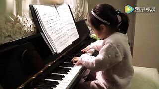 A young child skilled at playing the piano