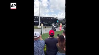 Eric Trump drives his dad around on a golf cart in his Florida resort.