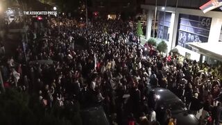 Hundreds of protesting students in Serbia block public TV station building.