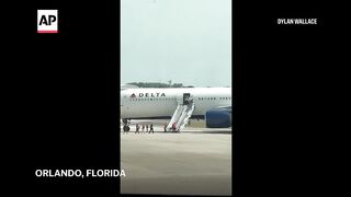 Video shows Delta plane on fire at a Florida airport.