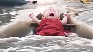 The cat save a little baby who is flowing in the water