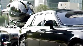 Rolls-Royce Hauling a Helicopter Through the City Streets