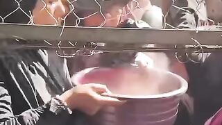 In Khan Younis, hungry Palestinian children gather around a small kitchen