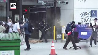 Police and protesters clash outside federal detention center in LA after ICE raids.