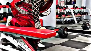 A South Asian girl in a sari is working out in the gym.