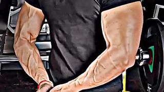 A Desi boy shows off his arm muscles in the gym after his workout.