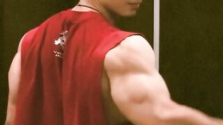 A bodybuilder striking a pose that showcases their biceps and chest.