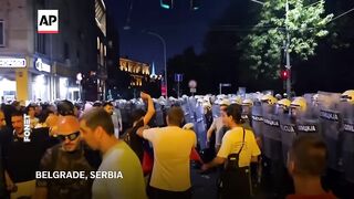 Anti-government protesters clash with riot police in Serbia during massive