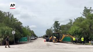 Workers install Alligator Alcatraz sign for Florida immigration detention