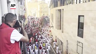Daredevils run with charging bulls at famous festival in