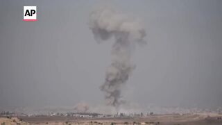 Multiple explosions send huge plumes of smoke into the sky over