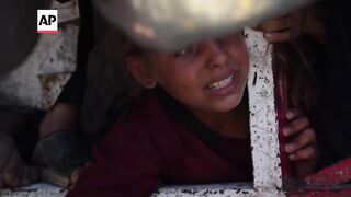 Desperate Palestinians jostle for food at charity kitchen in