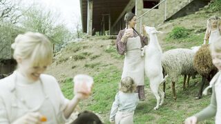 Women and Children Feeding Farm Animals