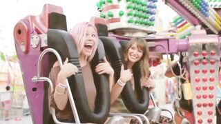 Two Girls Enjoying a Thrilling Amusement Park Ride