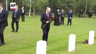 Putin lays flowers at graves for Soviet World War II pilots during Alaska